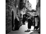 This picture illustrates a narrow thoroughfare in the little Judaean town of Bethlehem. An early photograph.